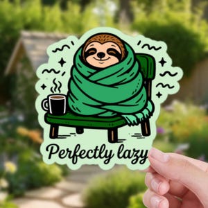 May include: A sticker depicting a cartoon sloth wrapped in a green blanket, seated on a green chair, with a coffee mug. The text "Perfectly lazy" is below the sloth. The sticker has a light green border with decorative elements.