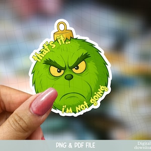 Op de afbeelding: Een groene Grinch-thema sticker met de tekst "That's it. I'm not going." De sticker toont het gezicht van de Grinch met een boze uitdrukking en gele ogen. De sticker heeft een goudkleurige ornamentkap.