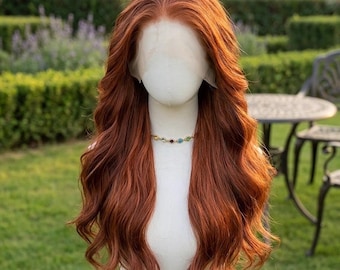 May include: A long, wavy wig in a vibrant copper-red shade featuring a lace front construction. The hair is styled with a center part and loose, flowing waves that cascade down the shoulders. The wig is displayed on a plain white mannequin head.