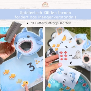 May include: A set of educational counting cards featuring 70 feeding task cards with illustrations of marine animals like sharks, pelicans, and seals. The cards display numbers and corresponding quantities of fish to help children learn basic math skills.