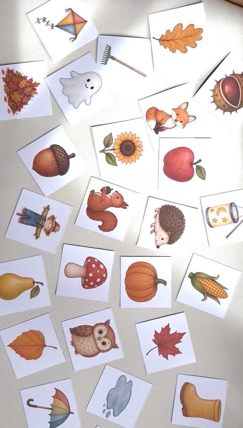 May include: A collection of square cards featuring watercolor illustrations of autumn-themed subjects including a kite, rake, ghost, leaves, chestnut, fox, acorn, sunflower, apple, scarecrow, squirrel, hedgehog, lantern, pear, mushroom, pumpkin, corn, owl, umbrella, puddle, and boot.