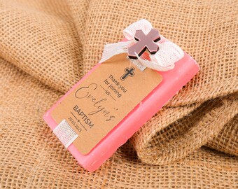 May include: Pink soap bar with a brown tag that says "Thank you for joining us - Evelyn's Baptism 20.05.2025". The tag is tied with a white ribbon and a silver cross.