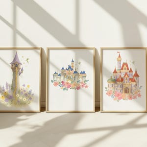 May include: Three framed watercolor prints featuring fairytale castles and a tower. The prints showcase pastel colors, floral accents, and whimsical details. Each print is set in a light brown wooden frame, creating a cohesive set for wall decor.