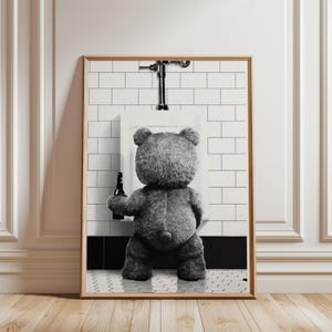 May include: A black and white photograph of a teddy bear holding a bottle of beer, standing in front of a urinal in a tiled bathroom.