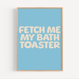Puede incluir: Una impresión enmarcada azul claro con el texto "Fetch me my bath toaster" en una fuente de color crema.