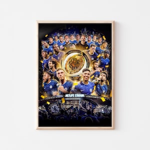 May include: A framed poster featuring a collage of soccer players in blue jerseys, celebrating a championship win. The poster includes the text "Club World Cup Champions" and "Metlife Stadium."