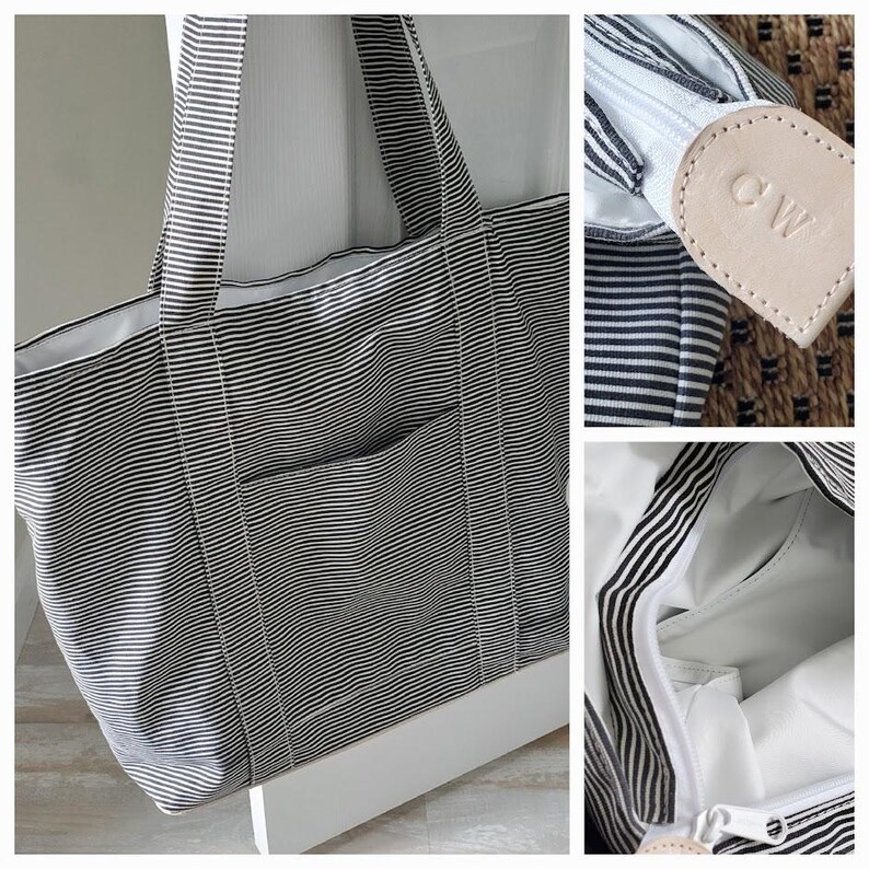 May include: A large tote bag with black and white horizontal stripes. The bag has a front pocket and a white interior. The zipper pull is a light tan leather with the initials "CW" embossed on it. The bag has two black and white striped handles.