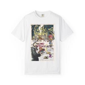 May include: White t-shirt with a vibrant graphic from the video game "Chrono Trigger." The design showcases characters and the game's logo. The shirt is made of a soft material and has a classic crew neck.