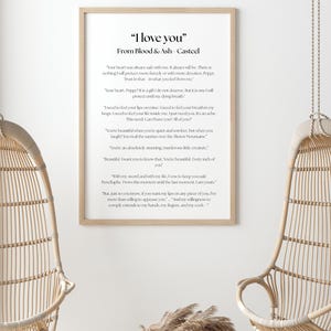 May include: A framed print with the text "I love you" from Blood & Ash Casteel. The print is in a light wood frame and hangs on a white wall. Two wicker hanging chairs are in the foreground.