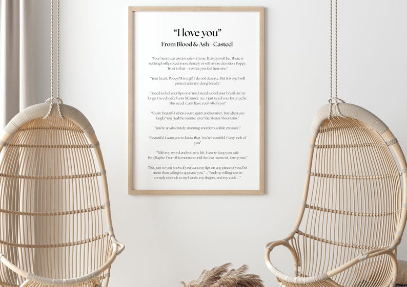 May include: A framed print with the text "I love you" from Blood & Ash Casteel. The print is in a light wood frame and hangs on a white wall. Two wicker hanging chairs are in the foreground.