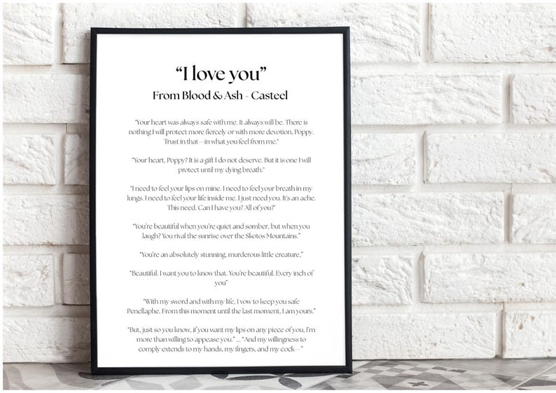 May include: Black framed print with the text "I love you" from Blood & Ash Casteel. The print features a poem with romantic verses in a clean, modern font. The background is a white brick wall.
