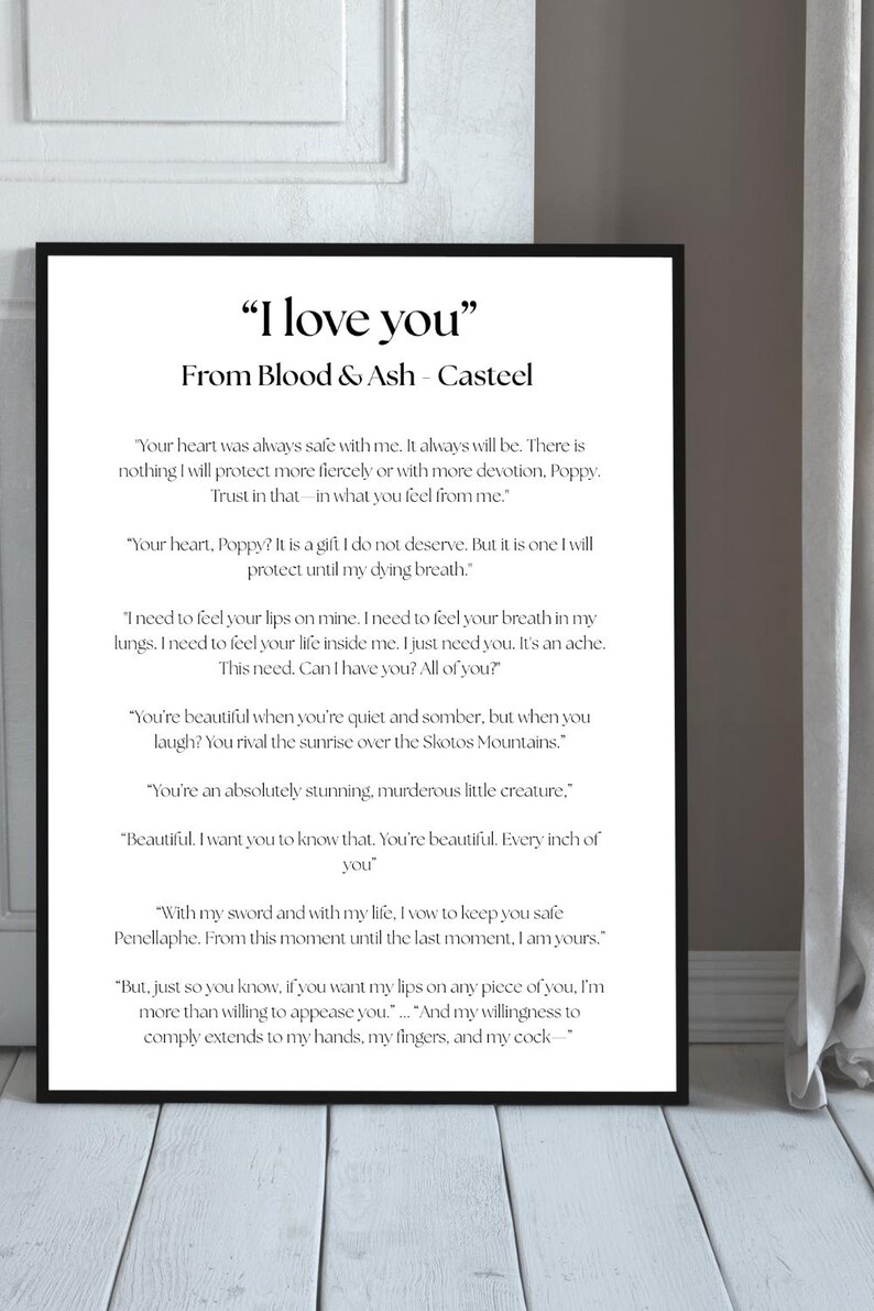 May include: Black framed print with the text "I love you" from Blood & Ash - Casteel. The print features a black frame and white text on a white background. The text is a romantic quote.
