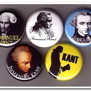 May include: Five round buttons with images of Immanuel Kant. The buttons are black, white, blue, yellow, and brown. The text on the buttons includes "Immanuel Kant", "a priori", and "KANT".