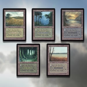 May include: Five Magic: The Gathering cards with a brown background. Each card features a landscape scene with a different color scheme. The cards are titled "Windswept Heath", "Misty Rainforest", "Polluted Delta", "Verdant Catacombs", and "Marsh Flats". Each card has the same text: "Pay 1 life, Sacrifice [Card Name]: Search your library for a [Land Type] card, put it onto the battlefield, then shuffle."