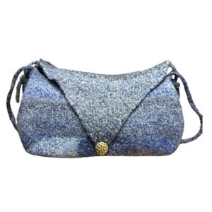 May include: A blue and gray wool crossbody bag with a flap closure and a gold-colored button. The bag has a textured appearance and a long, adjustable strap. The bag is approximately 10 inches wide.