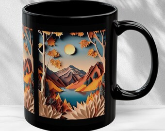 May include: Black ceramic coffee mug with a colorful paper cut-out design of a mountain landscape with a lake and a sun. The design is framed in a black rectangle.