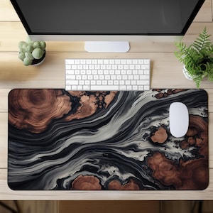 May include: A rectangular desk mat featuring a high-resolution print of swirling black and white marble patterns interspersed with circular brown wood grain cross-sections, creating a fluid, organic aesthetic across the entire surface area.