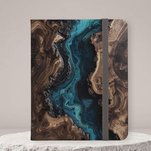 May include: A rectangular notebook featuring a cover with a printed design of dark brown wood grain patterns flanking a central, flowing river-like section of vibrant turquoise and deep blue swirls, secured by a vertical gray elastic band.
