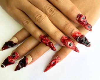 幽霊が出る吸血鬼の押し付けネイル、ハロウィンパーティー用の怖いロングスティレットネイル、目玉付きのカスタムフェイクネイル、出血ステッチ、トレンディなネイル