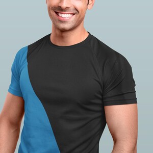 May include: A man wearing a black and blue t-shirt with a diagonal color block design.