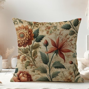 May include: A decorative throw pillow with a floral pattern featuring orange, red, and green flowers on a beige background.