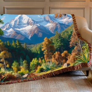 A beautiful vivid display of a mountainous background with a forest setting. Stitched scenic display of nature makes this comfy woven blanket perfect for all nature enthusiasts, and as a home decor gift. Great for a cozy night in.
