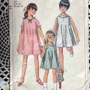 May include: Simplicity sewing pattern number 7038 for a girl's dress. The pattern is for a size 12 with a 30 inch bust. The pattern shows three girls wearing different styles of dresses. The first girl is wearing a pink dress, the second girl is wearing a striped dress, and the third girl is wearing a white dress with a floral pattern. The pattern is priced at 50 cents.