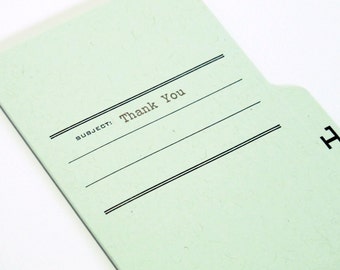 May include: A light green file folder with a black tab and the text "SUBJECT: Thank You" printed on the front.