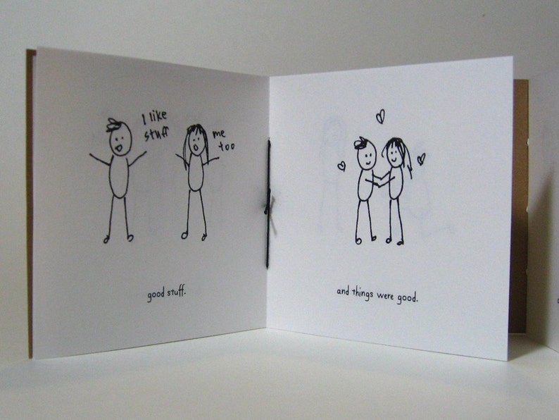 May include: A hand-drawn illustration of two stick figures. The first figure says "I like stuff" and the second figure says "me too". The caption below the figures says "good stuff". The second page of the illustration shows the two stick figures holding hands and the caption says "and things were good."