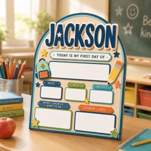 May include: An arched wooden sign with the name JACKSON in large blue letters. It features blank white spaces for date, age, height, future career, and interests. The board includes colourful icons of a backpack and pencil, with text reading TODAY IS MY FIRST DAY OF.