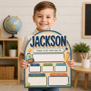 May include: An arched wooden sign with the name JACKSON in blue letters at the top. It features text that reads TODAY IS MY FIRST DAY OF, with blank spaces for date, age, height, career goals, and interests, decorated with a backpack and pencil.