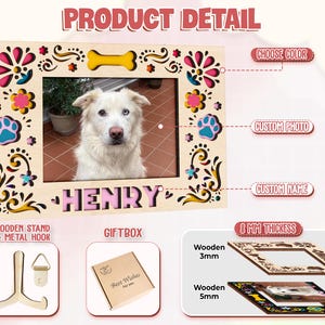 May include: A personalized wooden picture frame with a photo of a white dog named Henry. The frame has decorative floral and paw print accents, a yellow bone, and the text "HENRY". Includes a wooden stand, metal hook, and gift box.