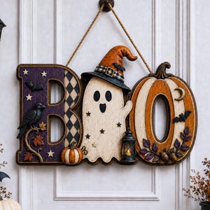 May include: A decorative wall hanging spelling the word BOO. The letter B is purple with a black and white diamond pattern and a black crow. The letter O is a white ghost wearing an orange hat, and the final O is an orange pumpkin with a lantern.