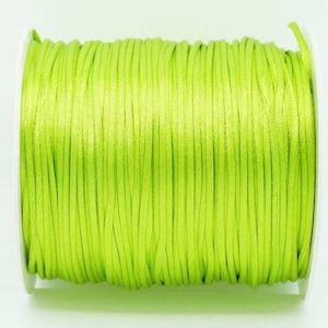 May include: A spool of bright green waxed cord, perfect for jewelry making, macrame, or crafts.