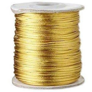 May include: A spool of gold-colored waxed cord.