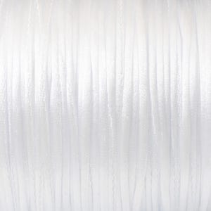 May include: A spool of white thread, perfect for sewing or crafting projects.