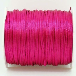 May include: A spool of bright pink waxed cord, perfect for crafting and jewelry making.