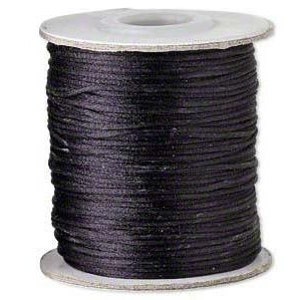 May include: A spool of black cord, tightly wound around a cardboard core. The cord appears smooth and has a slight sheen, suggesting a synthetic material. The spool's edges are visible, showing the cord's uniform thickness. Ideal for jewelry making or crafting.