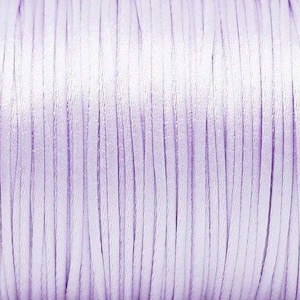 May include: A spool of light purple satin cord.