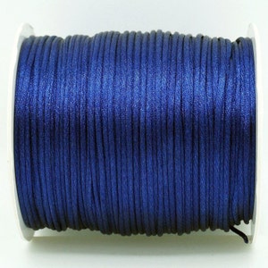 May include: A spool of dark blue waxed cord.