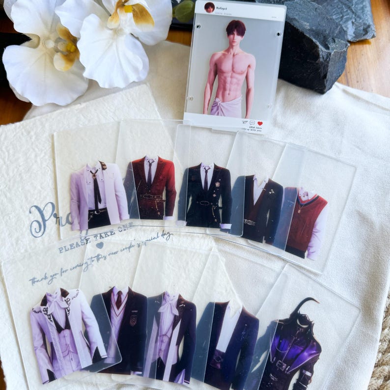May include: A collection of clear acrylic cards featuring images of formal wear, including suits and a vest, and a shirtless man. Some cards have text that reads "Please take one" and "Thank you for coming to this very simple special day."