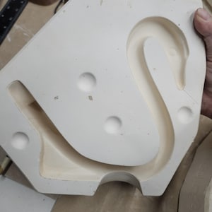 May include: A set of three ceramic mugs with a speckled, matte finish. The mugs are in shades of cream, light gray, and dark gray. Each mug has a simple, minimalist design and a rounded handle.