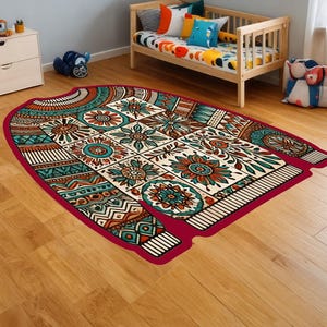 May include: A colourful patterned rug shaped like a sweater with a red border. The rug has a variety of colours including teal, orange, and brown.