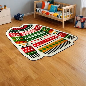 May include: A colourful Christmas jumper rug with red, green, white, yellow and black patterns. The rug is on a light wood floor.