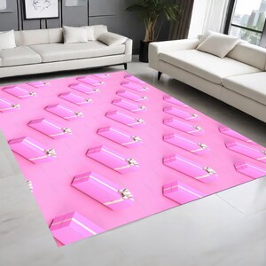 May include: Pink and white patterned rug with a repeating design of pink gift boxes with white bows. The rug is on a light wood floor.