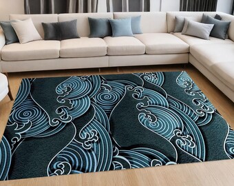May include: A rectangular area rug with a dark teal and white wave pattern. The design features stylized waves with swirling details, creating a textured, three-dimensional effect. The rug is placed on a wooden floor in front of a white sectional sofa.