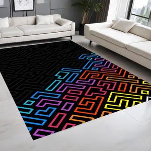 May include: A black and white geometric rug with a rainbow pattern of colorful lines. The rug has a modern design and would add a pop of color to any room.