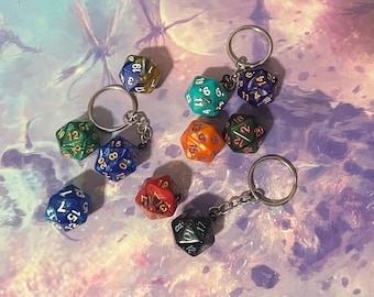 May include: A set of nine multi-colored dice with gold numbers, attached to keychains. The dice are various shades of blue, green, red, and orange.
