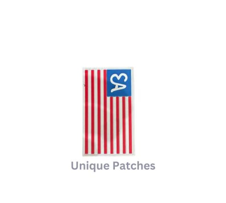 May include: A red, white, and blue American flag patch with the letters "SA" in a white heart on a blue background.