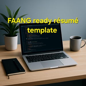 May include: A laptop displaying code sits on a wooden desk, with the text "FAANG ready résumé template" in yellow. A black notebook with a pen and a gray mug are also on the desk, along with a potted plant.
